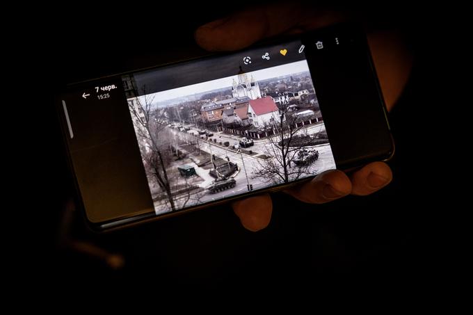 Duhovnik Galavin je pokazal fotografijo ruskih tankov, ki so zavzeli osrednjo cesto skozi Bučo.  | Foto: Ana Kovač