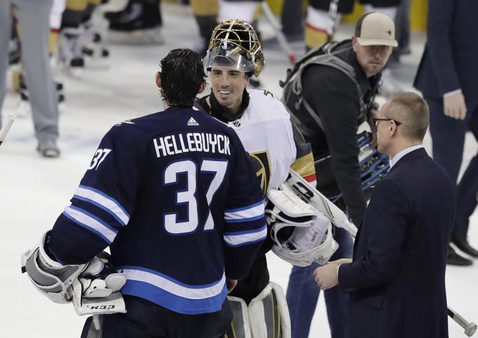 Vratar Connor Hellebuyck je športno segel v roke Fleuryju, enemu ključnih igralcev Vegasa. Bo prekaljeni vratarski maček osvojil tretji zaporedni, skupno pa četrti Stanleyjev pokal? | Foto: Reuters