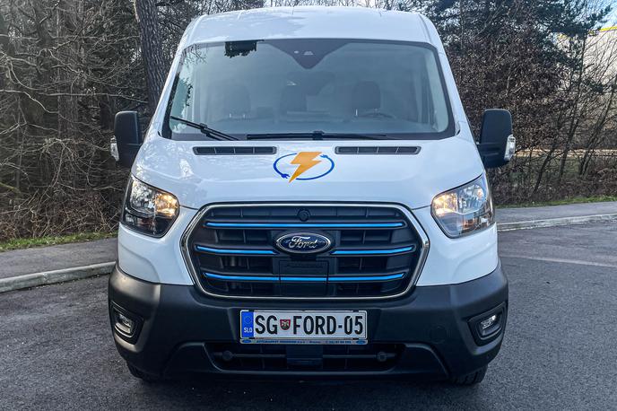 Ford e-transit | Pravzaprav se e-transit od transita z motorjem na notranje zgorevanje vizualno ne razlikuje. Le na maski hladilnika ima tri modre črte in lepo skrito polnilno mesto. | Foto Gašper Pirman