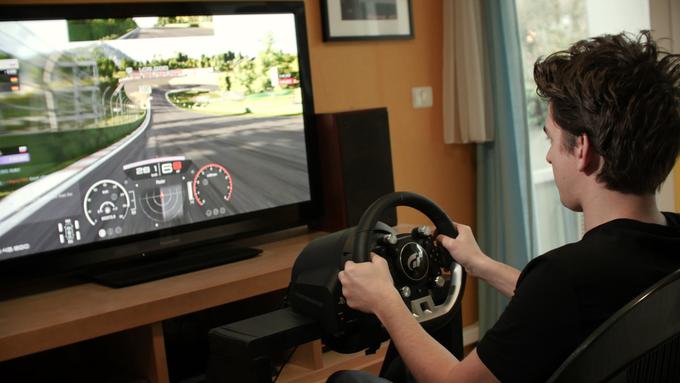 Luka za vožnjo uporablja volan Thrustmaster T-GT. Gre za vrhunski kos opreme, ki ga uporabljajo tudi na uradnih mednarodnih tekmovanjih v Gran Turismu Sport, cena se giblje okrog 600 evrov. Kakšna je razlika med tem volanom in volani, ki so dvakrat, trikrat, tudi šestkrat cenejši? "Natančnost, moč povratnega odziva (tresenje ob vožnji po neravni podlagi, drsenju ali močnem zaviranju) in pregrevanje. Drugi volani se začnejo ob dolgotrajnejši vožnji pregrevati, zaradi česar postanejo mehkejši, povratni odziv oslabi. T-GT lahko priganjaš zelo dolgo, pa se ne bo niti malo segrel. Meni osebno je sicer najbolj pomagal pri ocenjevanju oprijema - v zavoju s tem volanom vedno začutiš, kdaj gume izgubijo oprijem. To ti lahko pomaga določiti optimalno hitrost, s katero greš lahko v ovinek, in tudi pri varčevanju s profilom pnevmatik. S takšnim volanom le lažje voziti bolj prefinjeno in varčno, kar je na daljših dirkah zelo pomembno in kritičen del strategije," je bil izčrpen Zavišič. | Foto: Luka Zavišič