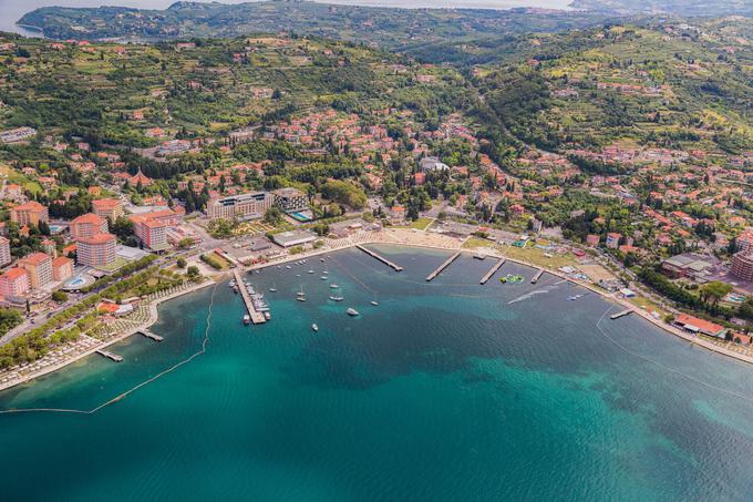 Portorož je priljubljena turistična točka na slovenski Obali, ki s svojo živahno promenado privablja številne slovenske in tuje goste, ki v mesto pridejo na oddih in zabavo. Leži med Piranom in Lucijo v zalivu z lepo oblikovanim flišnim gričevjem v ozadju, ki ga varuje pred mrzlimi vetrovi, njegova posebnost pa so tudi vrtnice, ki jih Portorož  nosi celo v imenu. Ne le urejene plaže, odlikuje ga tudi pestra ponudba pristne istrske kulinarike in bližina naravnih znamenitosti, kot so Sečoveljske soline, Mesečev zaliv in Strunjanski klif, ki vam bodo vzele dah. | Foto: 